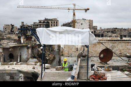Aleppo, Syria. 22nd Dec, 2018. A Syrian worker fixes the roof of the covered Souk al-Saqatiyya in Aleppo, northern Syria, on Dec. 19, 2018. In Syria's northern Aleppo city, the determination of the residents to rebuild their lives and city is stronger than the massive destruction that has befallen them. Two years since its liberation, people have already rolled up their sleeves and started fixing the destruction in the ancient walled marketplace in the city, not discouraged by the devastation. Credit: Ammar Safarjalani/Xinhua/Alamy Live News Stock Photo