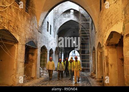 Aleppo, Syria. 22nd Dec, 2018. Workers carries out the rehabilitation work at the Souk al-Saqatiyya in Aleppo, northern Syria, on Dec. 19, 2018. In Syria's northern Aleppo city, the determination of the residents to rebuild their lives and city is stronger than the massive destruction that has befallen them. Two years since its liberation, people have already rolled up their sleeves and started fixing the destruction in the ancient walled marketplace in the city, not discouraged by the devastation. Credit: Ammar Safarjalani/Xinhua/Alamy Live News Stock Photo