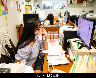 New York, USA. 31st July, 2018. A staff member works in Lisa International apparel company in New York, the United States, July 31, 2018. Credit: Wang Ying/Xinhua/Alamy Live News Stock Photo