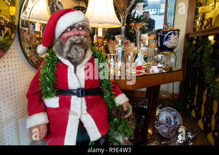 An old fashioned Santa doll in a shop window Stock Photo