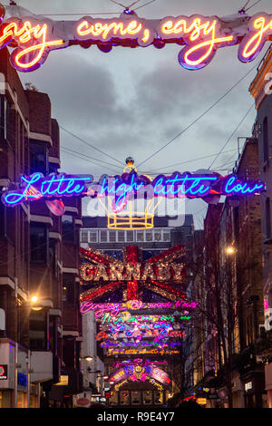 Neon lights over Carnaby Street at Christmas time - easy come, easy go Stock Photo