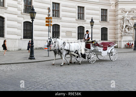 VIENNA, AUSTRIA - AUGUST 20, 2018: Horse drawn carriage in front of Hofburg Palace Stock Photo