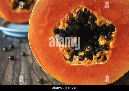Papaya, papaya on a plate and slices of papaya  on a fork, close up Stock Photo
