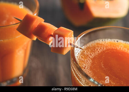 Papaya smoothie in a glasses and Papaya slices of Papaya close up Stock Photo