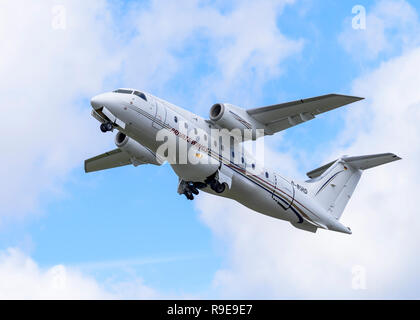 Fairchild-Dornier 328JET commuter airliner, in Private Wings Flugcharter livery, retracts its wheels after take-off. Stock Photo