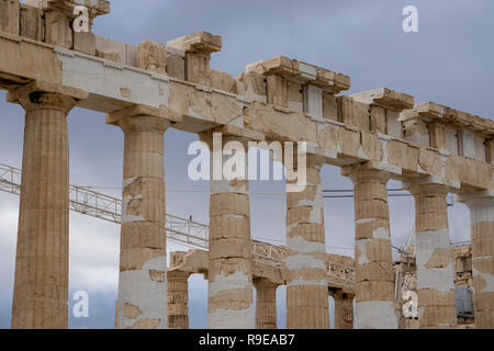 It is amazing to see how fragile our modern construction equipment looks in comparison to the magnificent columns of Parthenon. Stock Photo