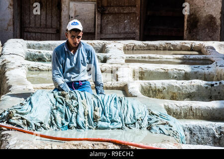 Fez - Morocco - September 29, 2018: Men working in the leather tanneries in Fez, Morocco Stock Photo