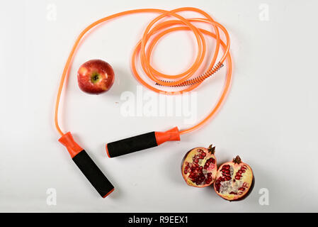 jumping rope and fruit isolated on white background. Stock Photo