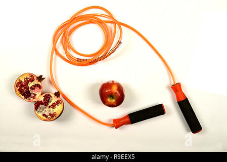 jumping rope and fruit isolated on white background. Stock Photo