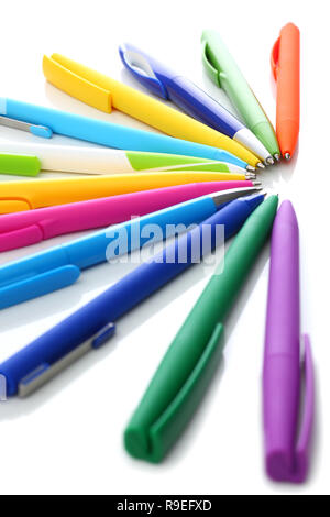 Multi colored ball pens on white background Stock Photo