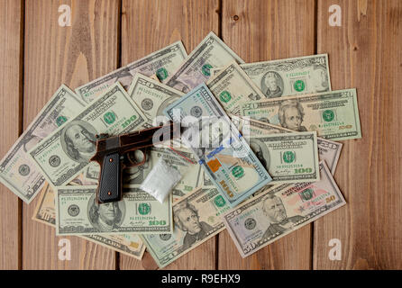 pistols and drugs against the background of dollars. Stock Photo