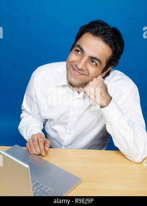 MAN WORKING ON COMPUTER IN AN OFFICE/CALL CENTRE Stock Photo