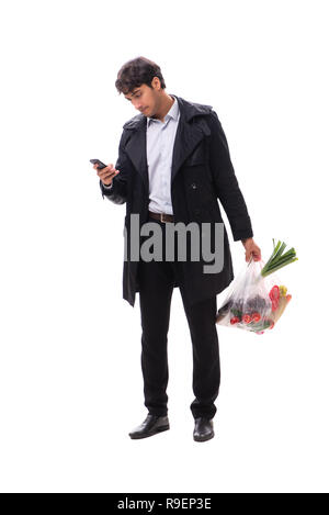 Young handsome man with vegatables in shopping concept Stock Photo