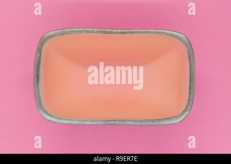 Top view of rectangular pink empty dish with silver edges on pink background Stock Photo