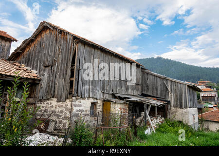 Old barn in very bad shape , wooden barn in ruin. Stock Photo
