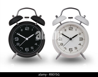 Two alarm clocks one Black and one White with the hands  set at 10 and 2 am or pm isolated on a white background with drop shadows Stock Photo