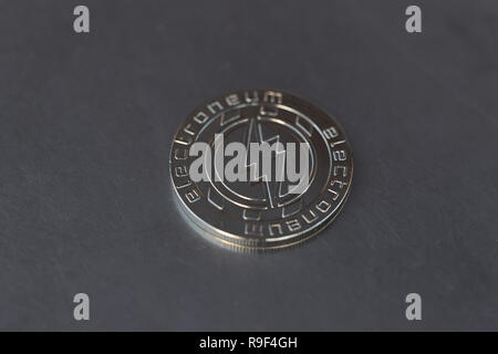 Electroneum cryptocurrency physical coin placed on the metal surface Stock Photo