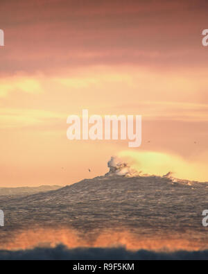 Crashing ocean waves sunset light Stock Photo