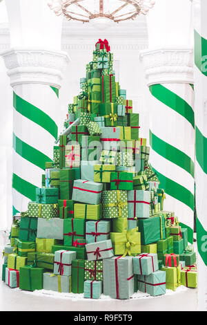 Christmas gift boxes laid out in the shape of a Christmas tree Stock Photo