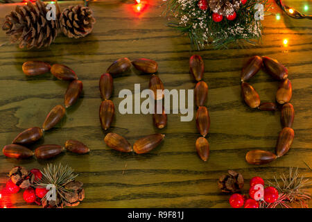 Christmas decoration. the New year is coming. Composition made of acorns with the inscription of 2019. Stock Photo