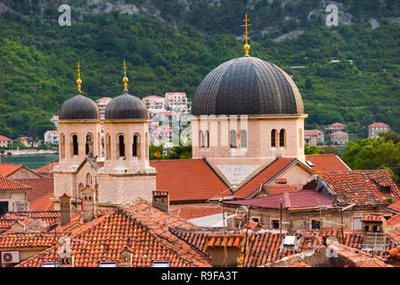 Serbian Orthodox Church of Saint Nicholas and red roof houses, Kotor, Montenegro Stock Photo