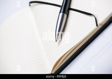 White notepad notebook lines elegant pen grey wooden background Stock Photo