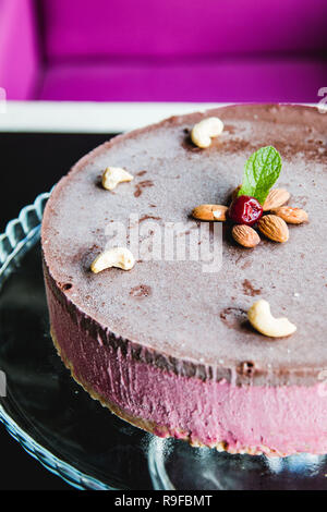 Delicious and healthy raw cake with fruit. chocolate and nuts Stock Photo