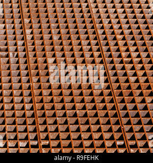 Rusty industrial floor with drainage grate sections, background texture Stock Photo