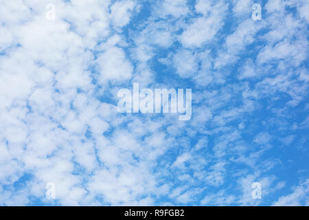 White fluffy clouds in blue sky background Stock Photo