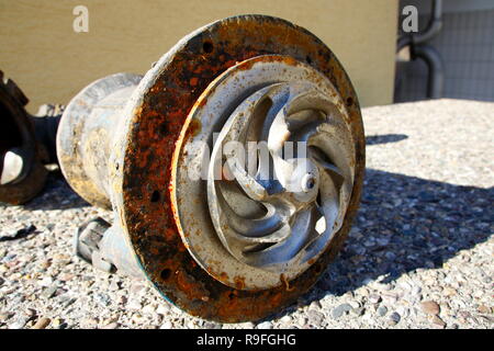 Impeller of a water pump. The impeller is heavily worn by stones ...