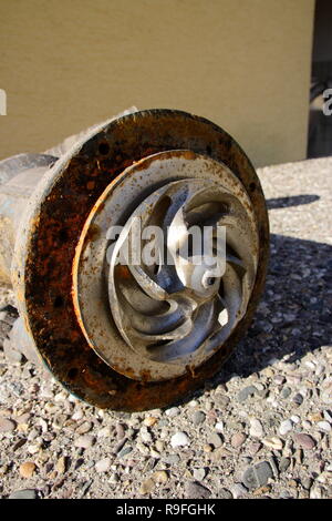 Impeller of a water pump. The impeller is heavily worn by stones ...