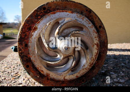 Impeller of a water pump. The impeller is heavily worn by stones ...