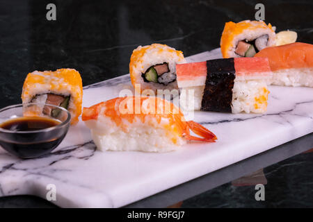 Sushi Set sashimi and sushi rolls served on stone slate Stock Photo