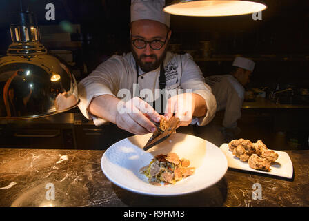 Chef grating truffles over pasta, Bangkok, Thailand Stock Photo