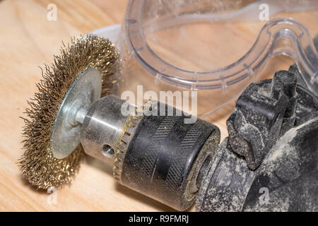Good old carpentry, woodworking tools. Electric drill with disc for working wooden surfaces and goggles on a wooden joinery table. Stock Photo