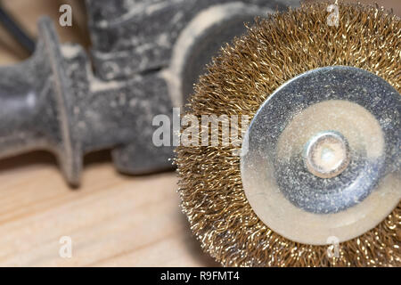 Good old carpentry, woodworking tools. Electric drill with disc for processing wooden surfaces on wooden joinery table. Stock Photo