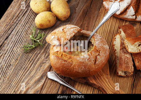 Homemade potato cream soup, served in bread bowl Stock Photo
