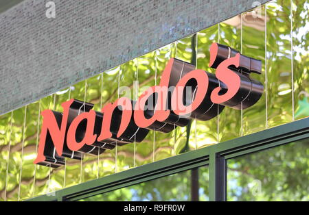 Dining at Nando's South African restaurant at night in Liverpool One ...