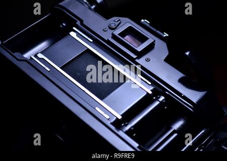 Close up shot of the film compartment, shutter and film advance crank of a 35mm film camera Stock Photo