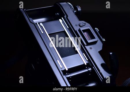 Close up shot of the film compartment, shutter and film advance crank of a 35mm film camera Stock Photo