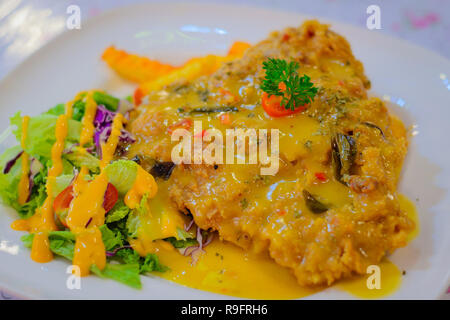 Salted Egg Deep Fried Chicken Chop with fries and salad Stock Photo