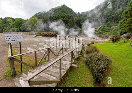FURNAS - PORTUGAL, AUGUST 4: A wooden path snaking around active thermal vents near Furnas, Portugal on August 4, 2017. Stock Photo
