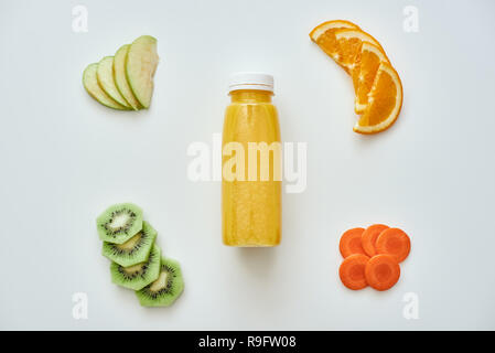 Low callories food. Fresh orange smoothie with fruits isolated in white background. Orange, apples, carrot and kiwi Stock Photo