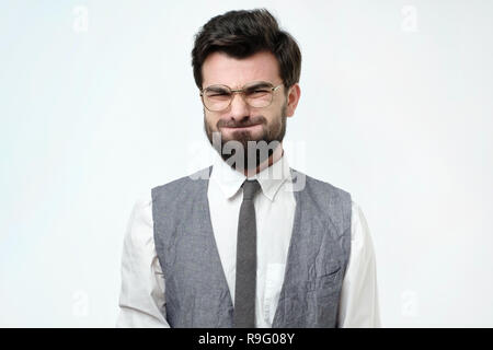 Funny young man grimacing, inflating cheeks, holding his breath. Stock Photo