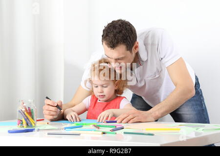 A male educator or a vather doing painting together Stock Photo