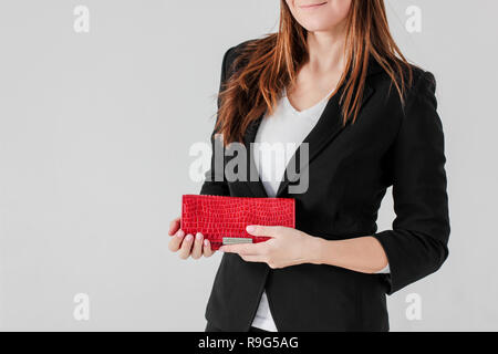 Crop photo of smiling women in black suit with red purse on gray background isolated Stock Photo