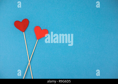 Two felt hearts on a blue background. Stock Photo