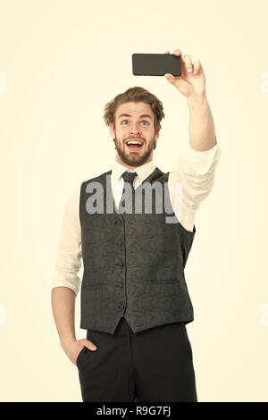 Buy online and digital marketing. happy man with mobile or cell phone. Business and communication. Guy presenting product of smartphone. Businessman with phone in outfit isolated on white background. Stock Photo