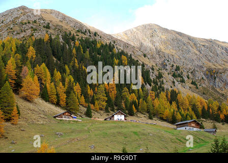 Hiking in the 'Hirzer' area with impressive autumn scenery, Sarntal Alps, South Tyrol, Italy. In the foreground the mountain inn 'Mandalm' Stock Photo