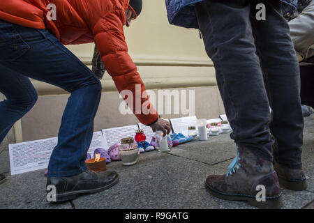 Warsaw, Poland. 23rd Dec, 2018. Protesters are seen lighting candles during the protest.The Nationwide Women's Strike (OgÃ³lnopolski Strajk Kobiet) organized the campaign called ''We accuse pedophiles''. At the gates of churches around Poland, children's shoes were hanged and candles were lightened to commemorate the victims of sexually abused children by Catholic priests. In Warsaw, the action took place in the Old Town's church of St. Anne. Credit: Attila Husejnow/SOPA Images/ZUMA Wire/Alamy Live News Stock Photo